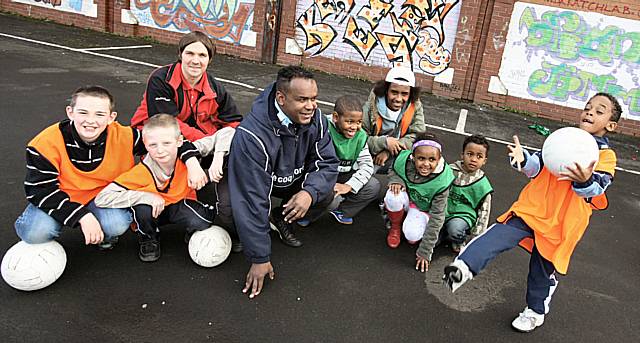 International Angolan football player, David Dias, trains Langley children in football skills at Bowlee Park Housing's Celebrating Diversity Event.