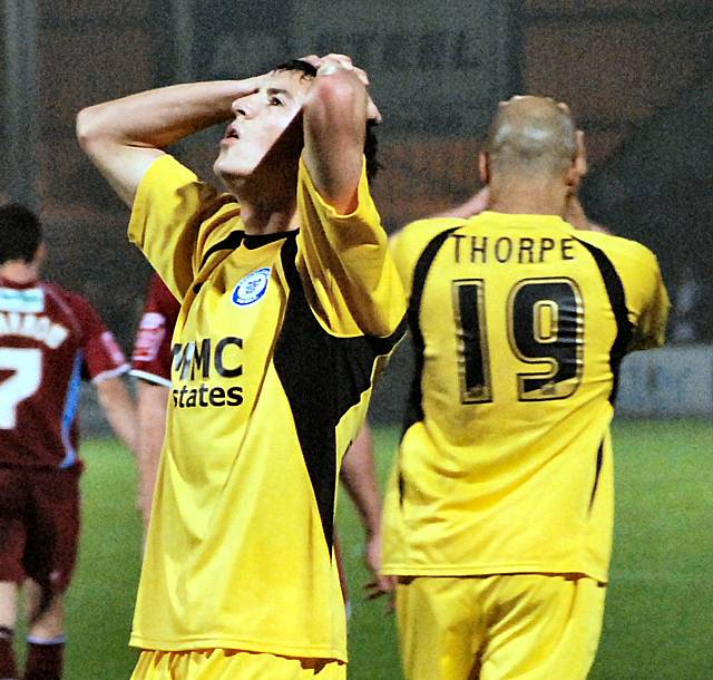 Buckley and Thorpe have their heads in their hands after seeing Chris Dagnall's shot deep into injury time go inches past the post.