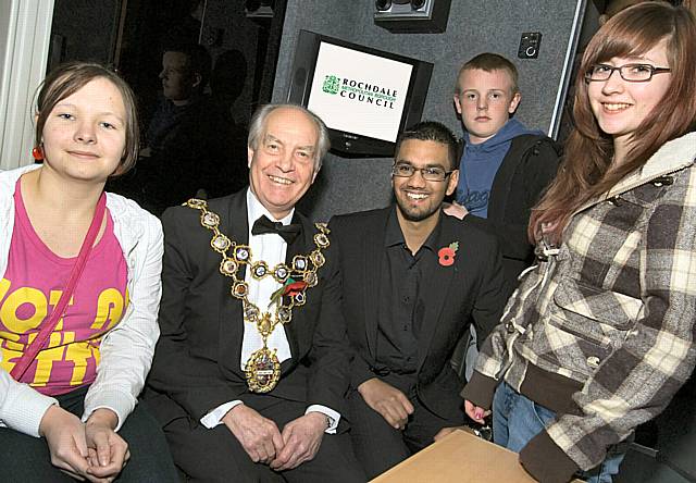 ON BOARD: The Mayor, Councillor Robin Parker and Usman Nawaz from Rochdale Youth Council with young people on board the new youth bus.