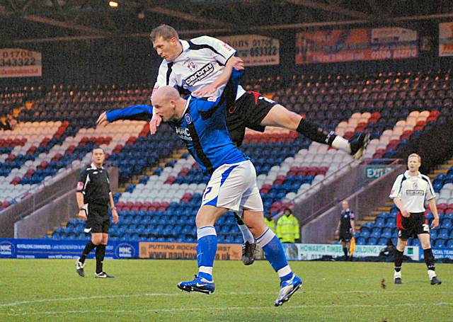 Lee McEvilly is used as a climbing frame by a Bournemouth defender.