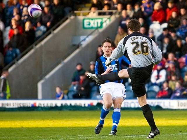 Luke Daniels clears the ball in front of Jon Shaw (Rochdale v Shrewsbury 26-12-08)