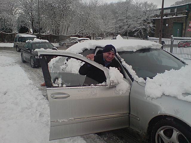 Sultan Mahmood pushes his car up Bentley Street.