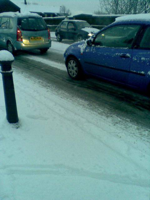 Traffic struggles through the snow on Manchester Road in Castleton.