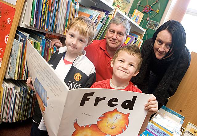 Making reading fun -Bowlee Park Housing community warden Stephen Squires and community initiatives officer, Tracey Evans with St Mary's pupils (l-r) Bailey Houghton and Stephen Kay