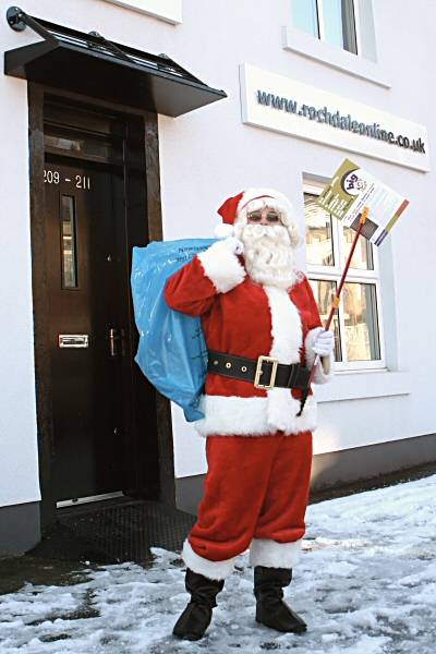 Father Christmas keeps things clean outside the Rochdale Online office on Bury Road.