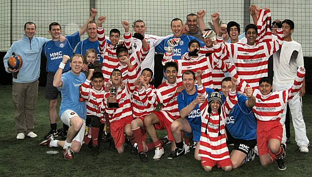 Rochdale Fire service and the young footballers celebrate the success outcome of the match.