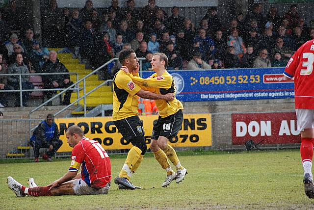 Higginbotham celebrates his goal with Rene Howe