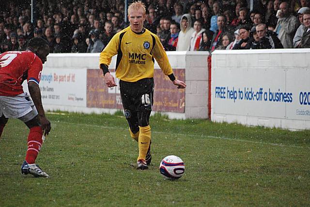 David Perkins looks to get past Jon Nurse as snow falls early in the first half