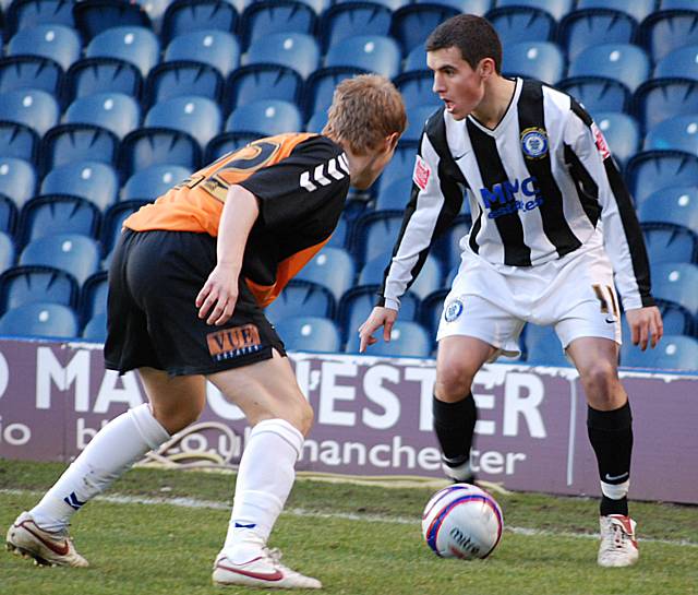 Adam Rundle takes on Barnet's Jordan Parkes