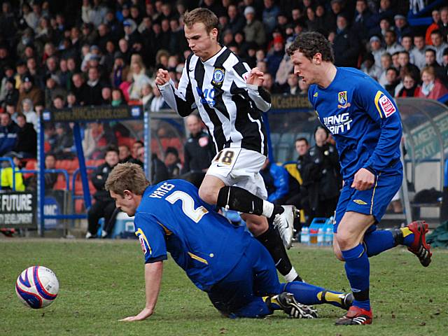 Kallum Higginbotham nicks the ball past Adam Yates