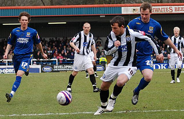 Adam Le Fondre looks to get the better of Henry McStay