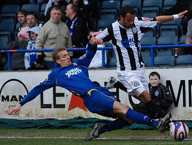 Ben Muirhead is tackled by Carl Baker