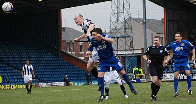 Jones wins a header against Garry Hunter