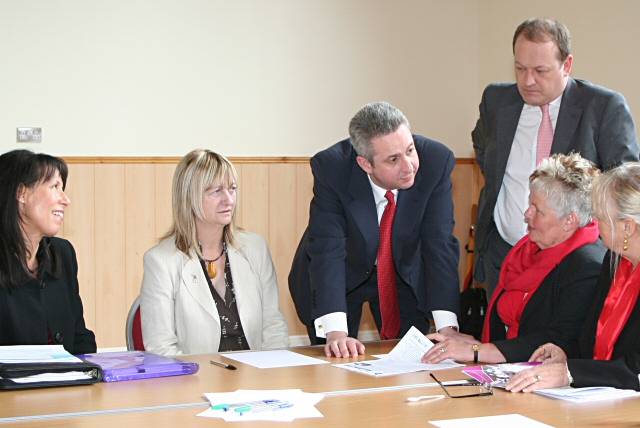 Ivan Lewis MP (standing) talks to Susan Coates (on Mr Lewis' right) and Ellen Wintle-Yates (to Mr Lewis' left) with Simon Danczuk (standing - back), Debbie Abrahams (far left) and Councillor Linda Robinson (far right) listening