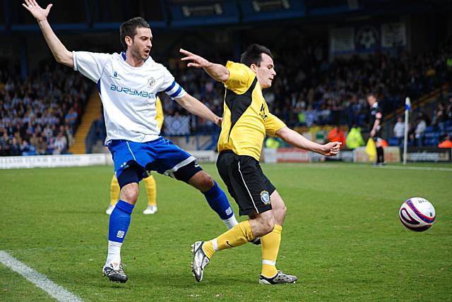 Dagnall tries to keep his balance as he comes away from a Bury defender