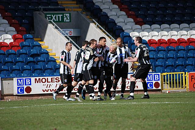 Celebration: Rochdale players celebrate after Howe opens the scoring