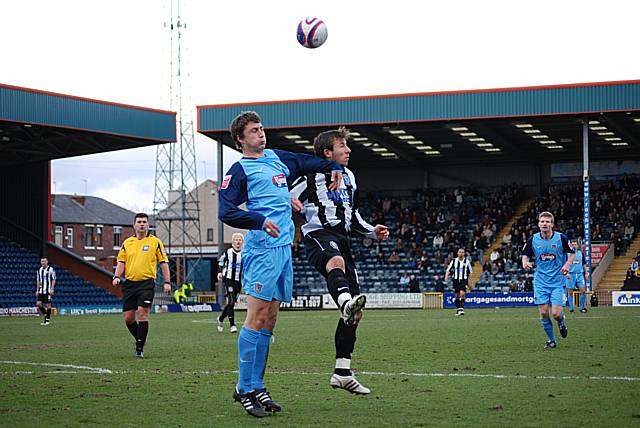 Head tennis: Adam Le Fondre rises for a header with former Dale player Jamie Clarke