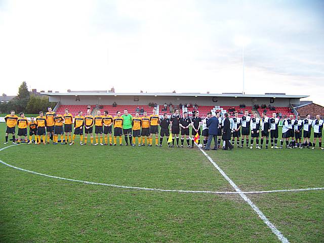 The two teams line up ahead of the game