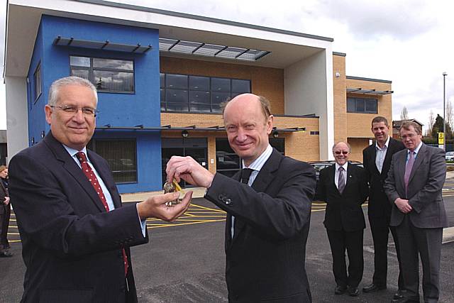 Director of Eric Wright, Mike Collier, hands over the keys to Trevor Purt, Chief Executive of Heywood, Middleton and Rochdale Primary Care Trust, as (L-R) Jim Dobbin MP, Justin Harris from Nightingale Associates and John Pierce, Chair of HMRPCT, look on.