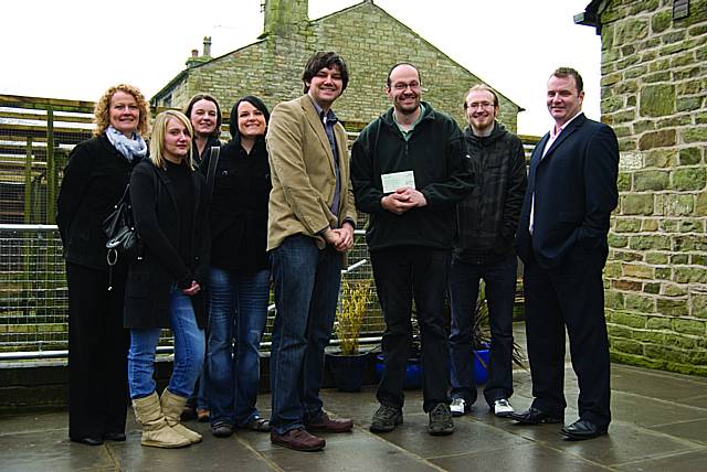 Nigel Fowler of Three Owls Bird Sanctuary holds a cheque for £200 donated by Dan Strayer of Arras People, with other Arras employees.