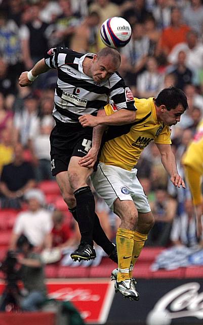 Alan White wins a header against Dagnall