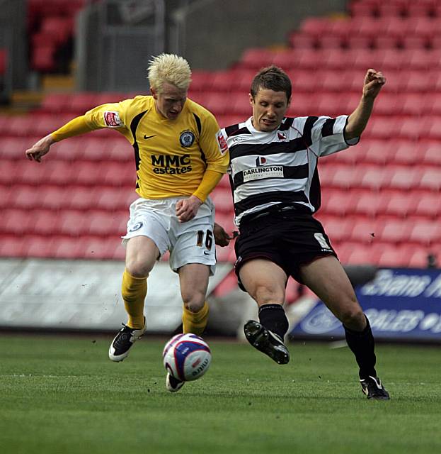 Perkins challenges for the ball with Ian Miller, Darlington's last minute goalscorer