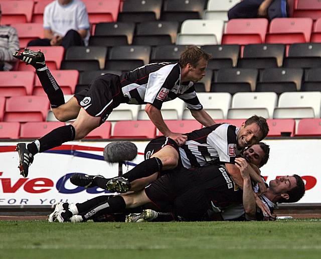 Darlington players mob Jason Kennedy after his stunning opener