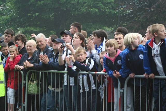 Supporters cheer the team's arrival