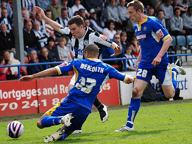 James Meredith puts in a tackle on Simon Ramsden