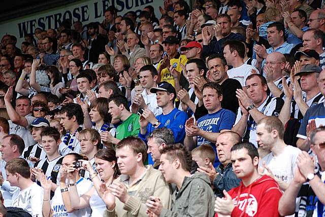 The fans take part in a minute's applause to celebrate the life of David Flitcroft's father