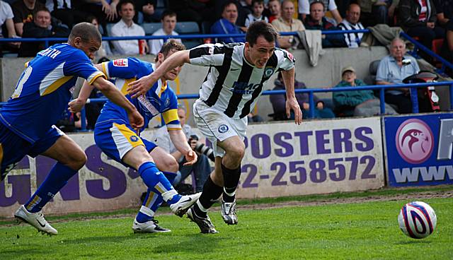 Dagnall gets away from two Shrewsbury defenders