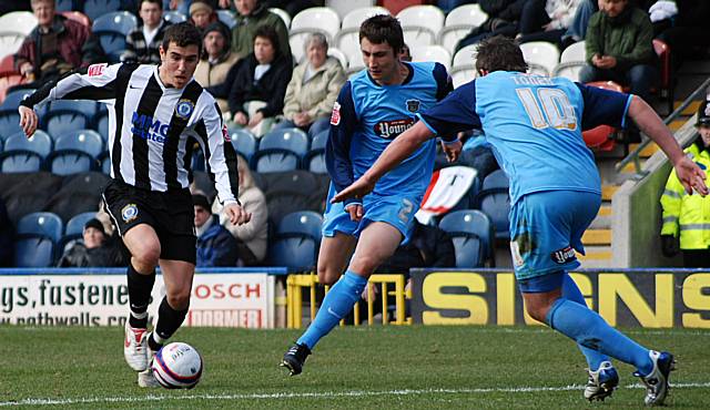 Toner in action against Dale during last season's game against Grimsby at Spotland