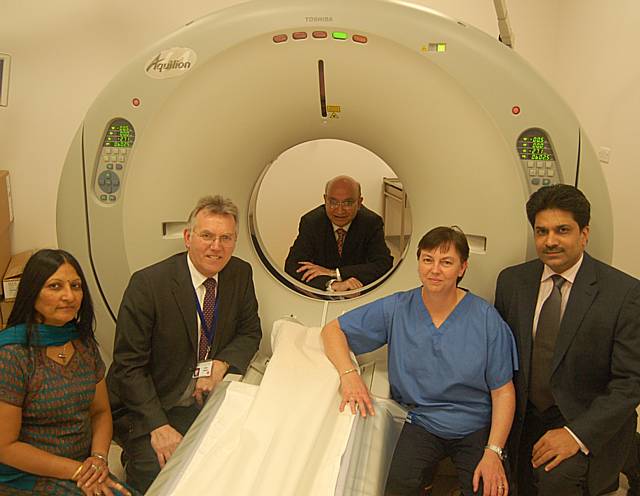 Shown with the new CT scanner at Rochdale Infirmary are (from the left): Dr Kundan Shah (consultant radiologist), John Saxby (chief executive of Pennine Acute Trust), Dr Ramesh Raja (site lead for radiology at Rochdale Infirmary), Dr Judith Mather (consul