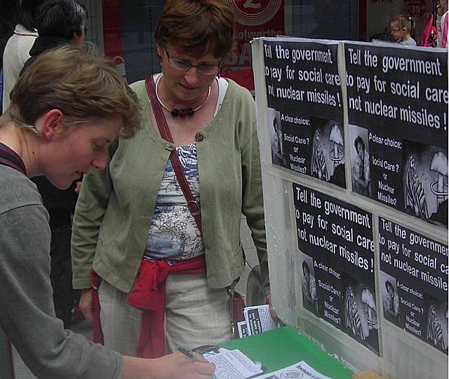 Peace Group member,Patricia Gilligan, looking on as a member of the public signs one of the letters in Yorkshire Street on Saturday