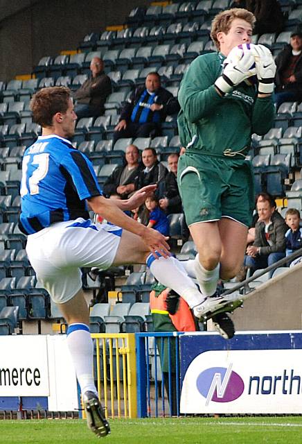 Stockport keeper Owen Fon Williams gathers in front of Jon Shaw