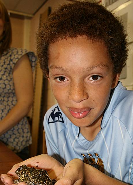 Little Heaton pupil holding an African bull frog in the animal care department