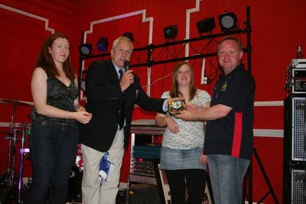 The Swarm being presented with a Bruff Rugby Club plaque by the Bruff president