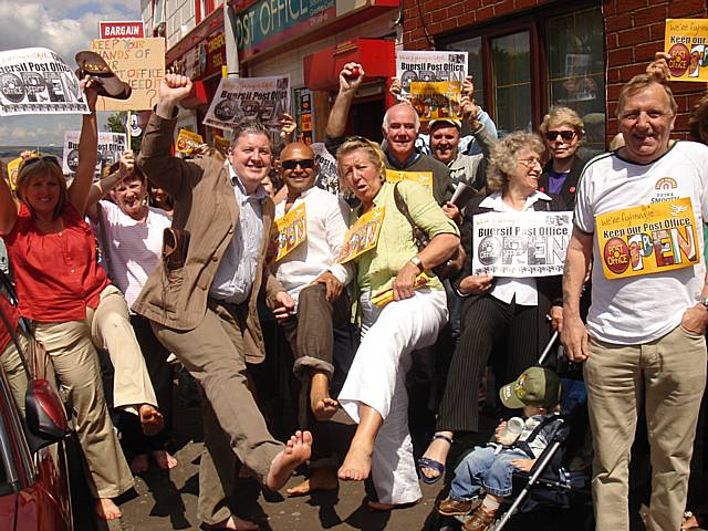 Councillors and members of the public waggle their toes in protest at the closure of Buersil Post Office