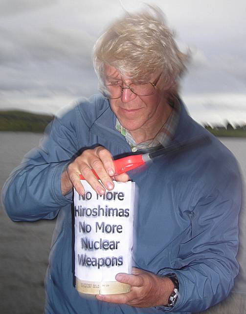 Phillip Gilligan lights the lantern to commemorate the war dead.