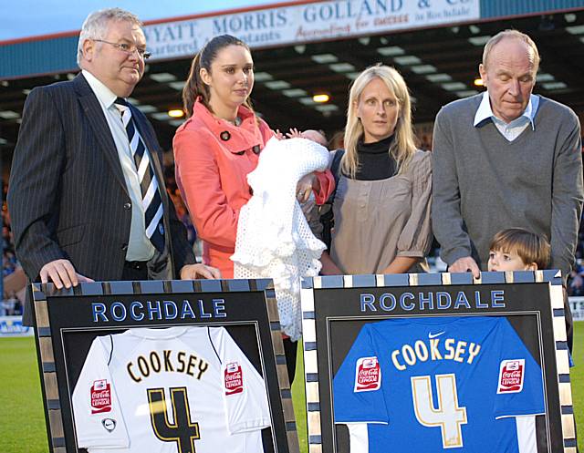 Rochdale chairman Chris Dunphy presents Ernie Cooksey's partner and baby daughter Isabella, and members of his family, with special commemorative shirts