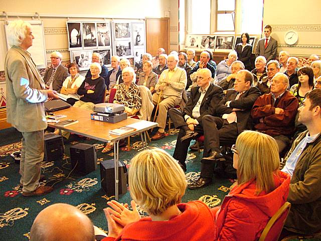 Geoff Tweedale speaks to a packed audience at Rochdale Town Hall