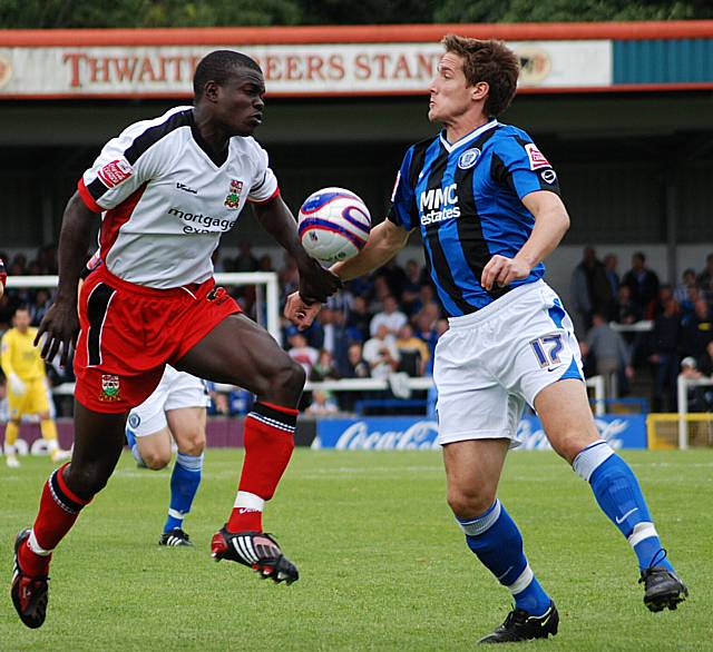 Jon Shaw battles for possession with Ismail Yakubu.