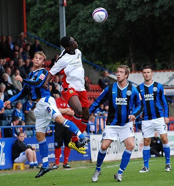 Joe Tabiri wins a header over Kallum Higginbotham