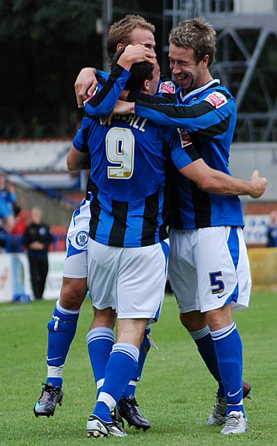 Keltie and Higginbotham celebrate with Dagnall after his goal gives Dale the lead