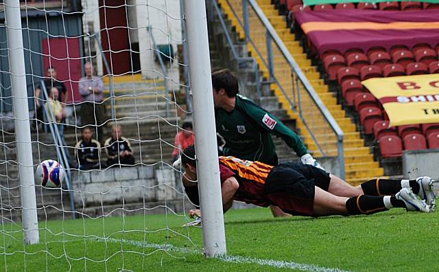 Paul Arnison heads the ball inches past his own post