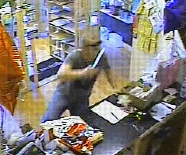 GMP have been encouraged by new measures to cut knife crime. This image shows a man robbing cash from a Middleton shop at knifepoint last month.