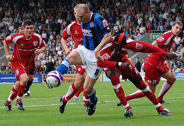 Gary Jones gets the better of Efe Sodje inside the Bury box