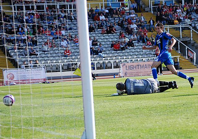 Buckley slots the ball past Warington to score his first professional career goal.