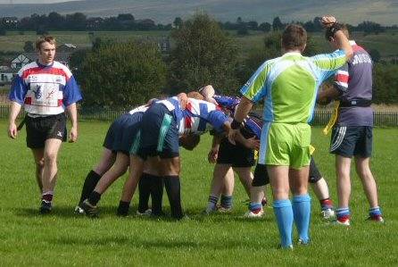 The two sides contest a scrum.