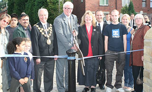 Rochdale MP Paul Rowen cuts the ribbon to officially open the new-look Oakenrod Bridge alongside Mayor Robin Parker, members of Eileen Sinclair's family, and Sparth residents. 